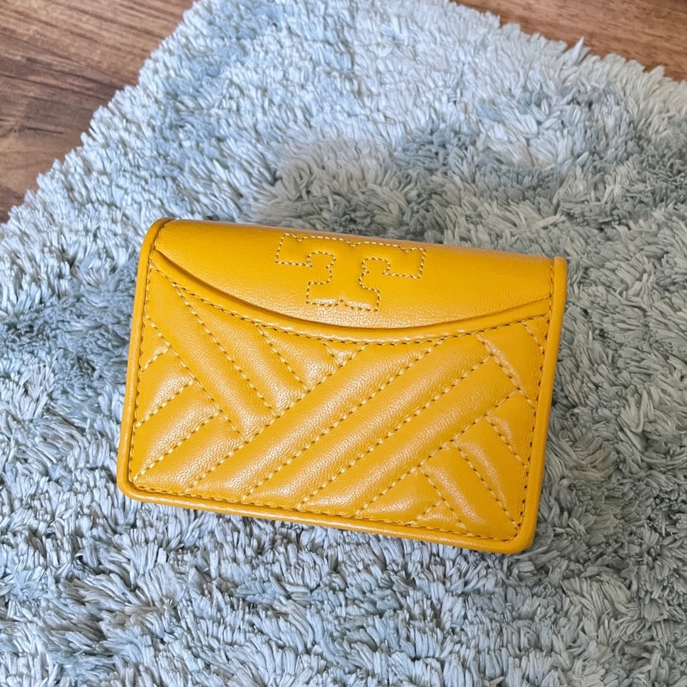 Tory Burch Alexa Foldable Mini Wallet daisy. golden yellow embossed pattern